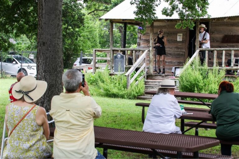 Musical performance outside at Knapp Heritage Park.