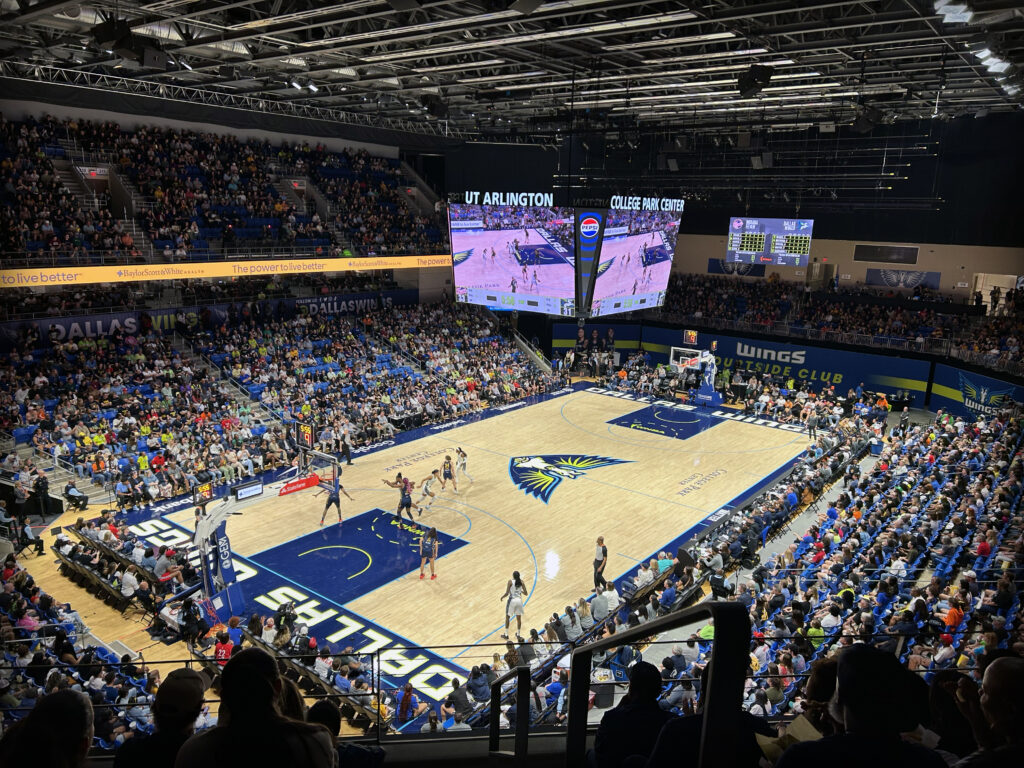 Aerial view of fans cheering on Dallas Wings basketball team.