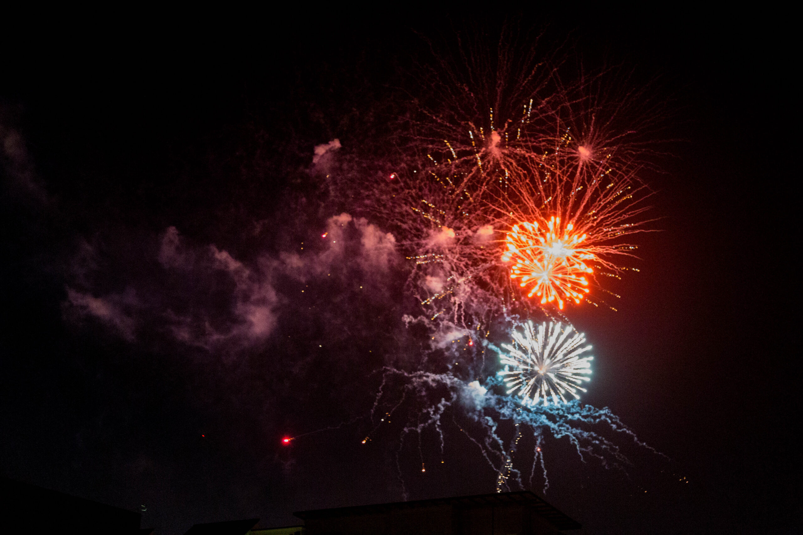 Fireworks visible in the night sky.