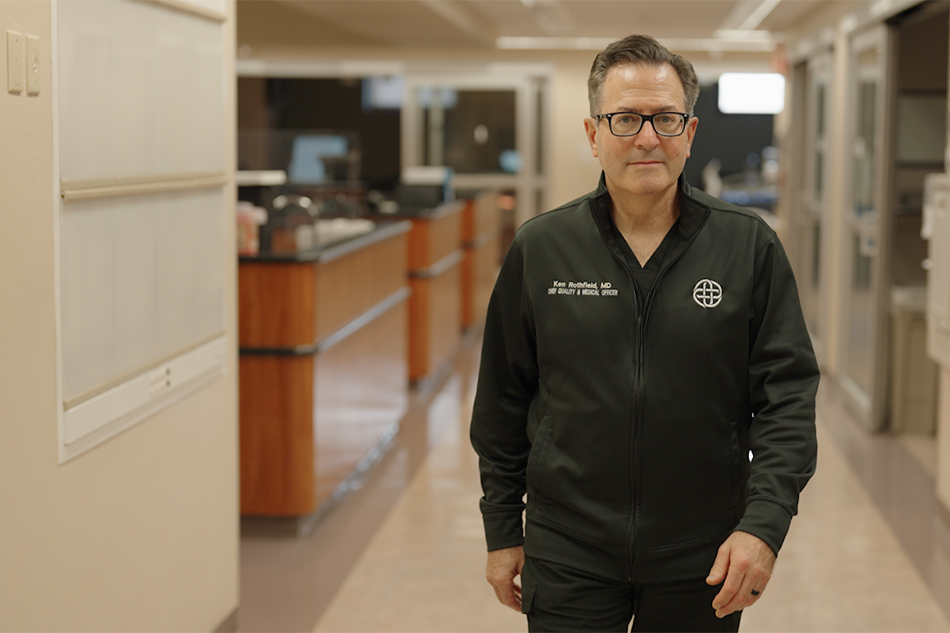 Dr. Ken Rothfield walks in the hallway of an empty intensive care unit.
