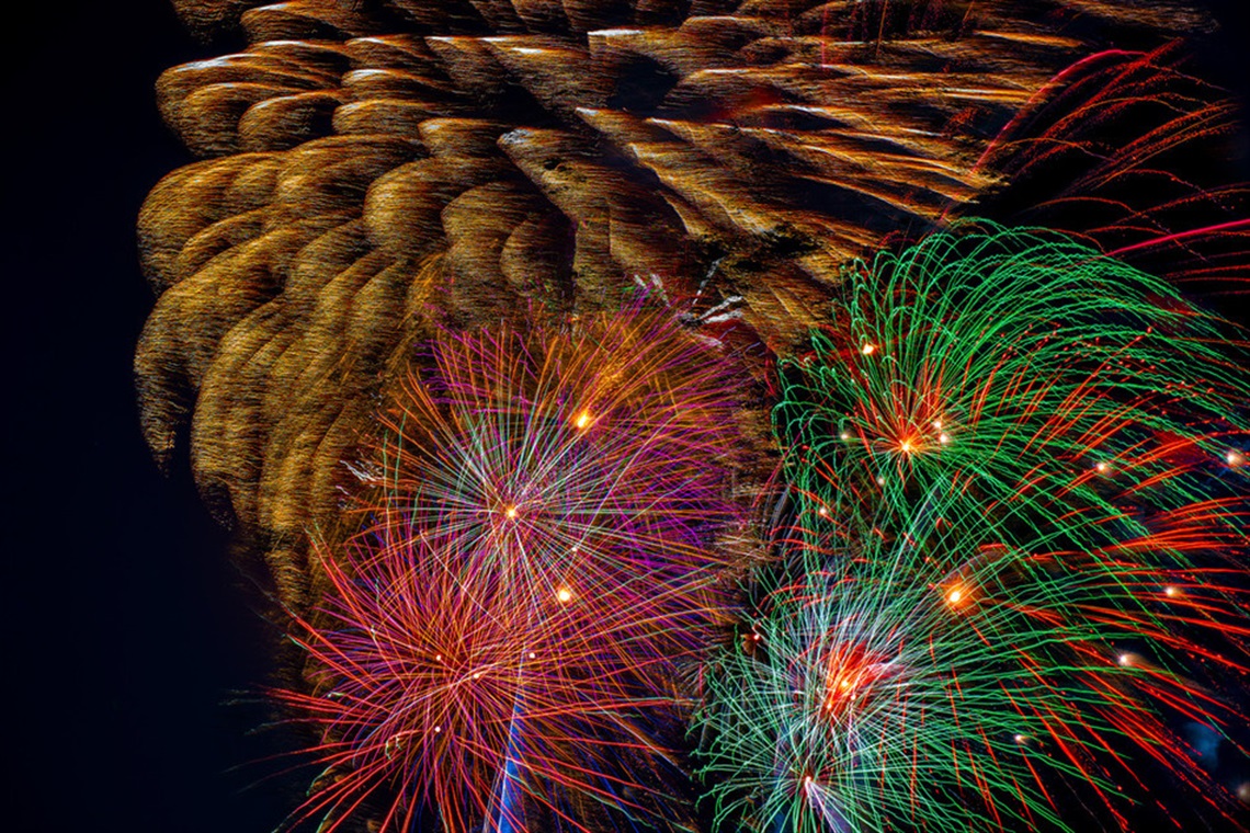 Multi-color fireworks in the night sky.