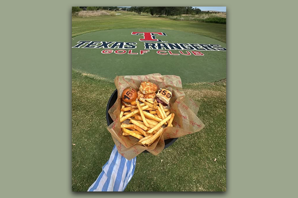 Person holding the special feature of three mini sliders: Chicken & Biscuit, Mini Rangers Burger and Smokehouse Pork.