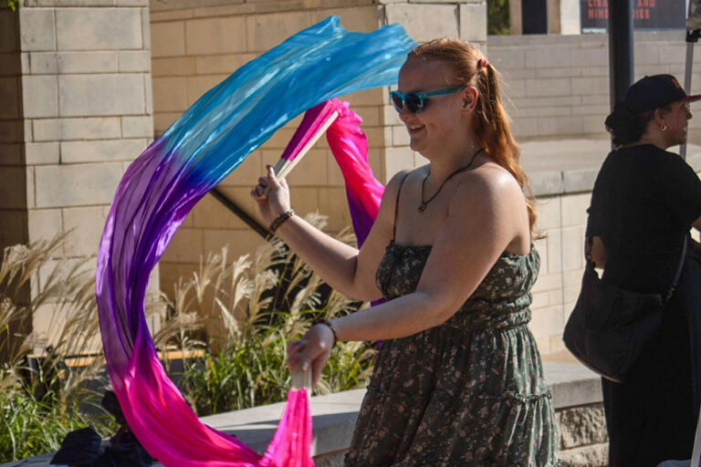Woman performing with silk fans.