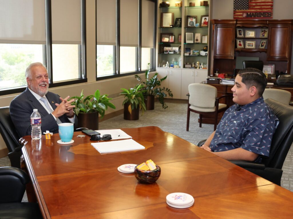 Arlington ISD student and honorary mayor for the day, Aaron Diaz, speaks with Arlington Mayor Jim Ross.
