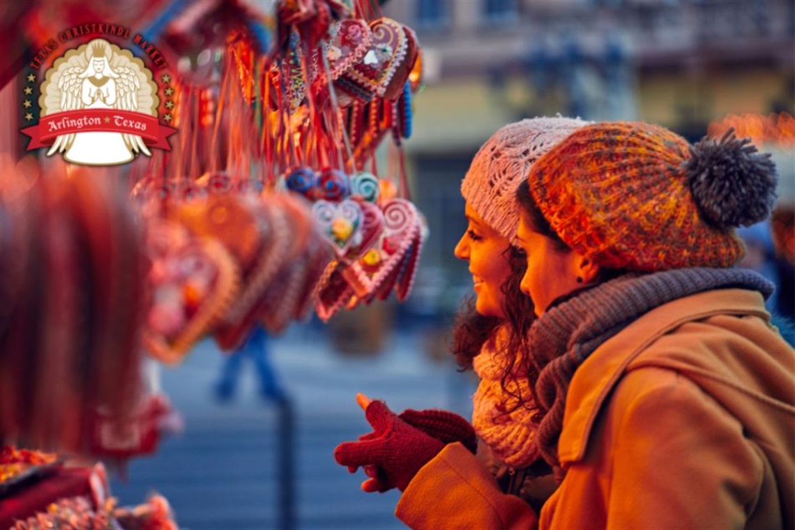 Two women looking at Christmas ornaments.